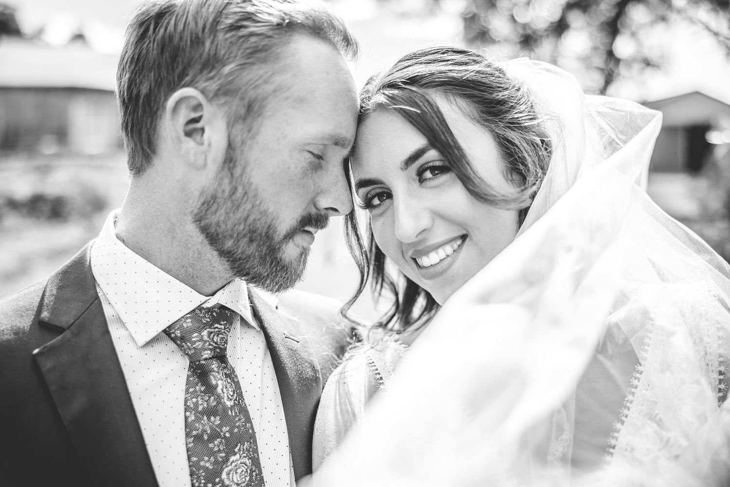 Black and white wedding portraits capturing intimate moments between the newlyweds.