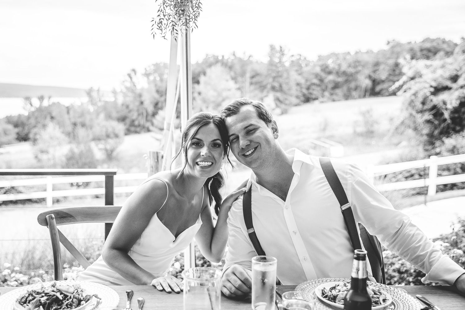 Black and white wedding photography capturing candid moments during an outdoor reception.