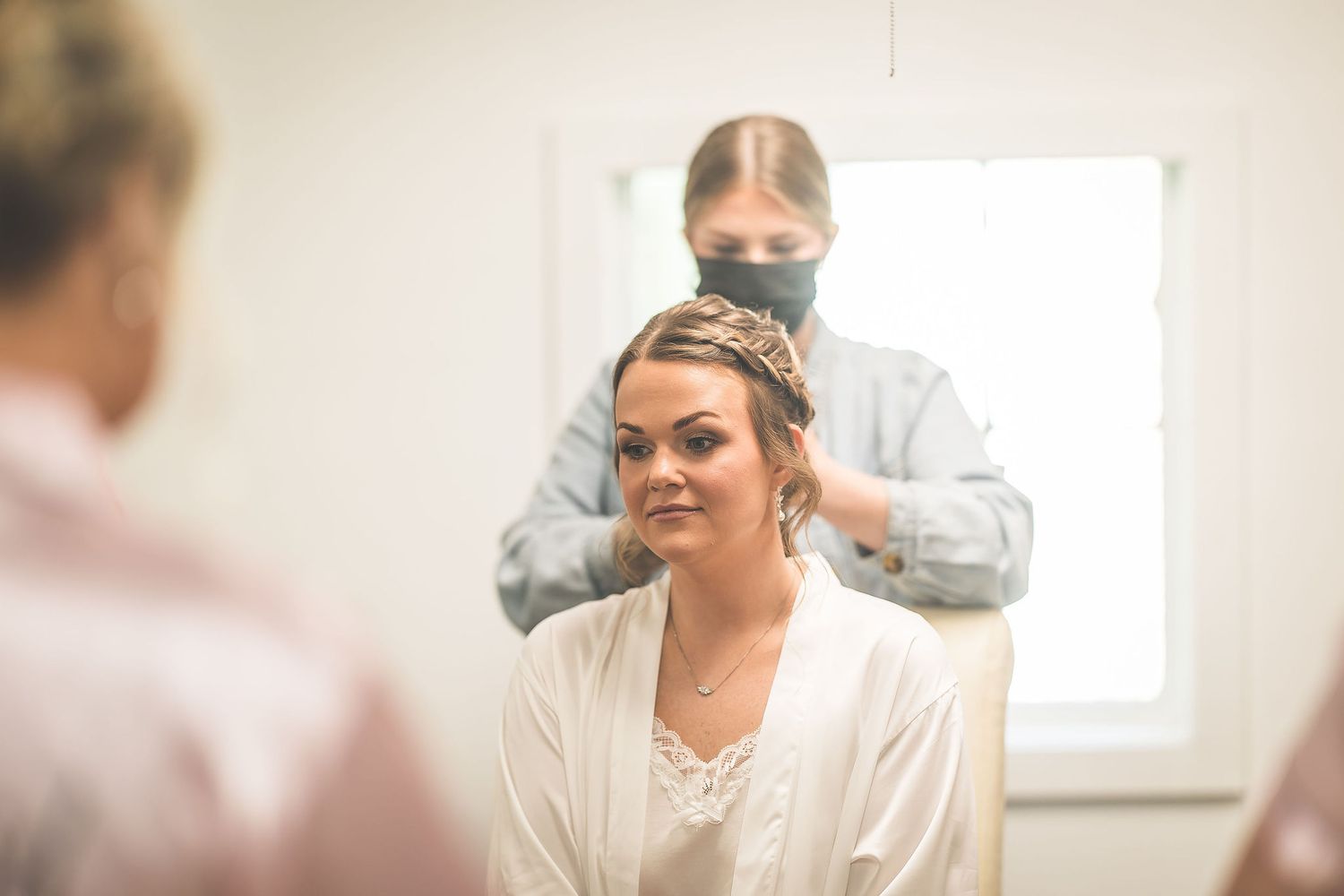 Wedding preparation scene in bright indoor setting.