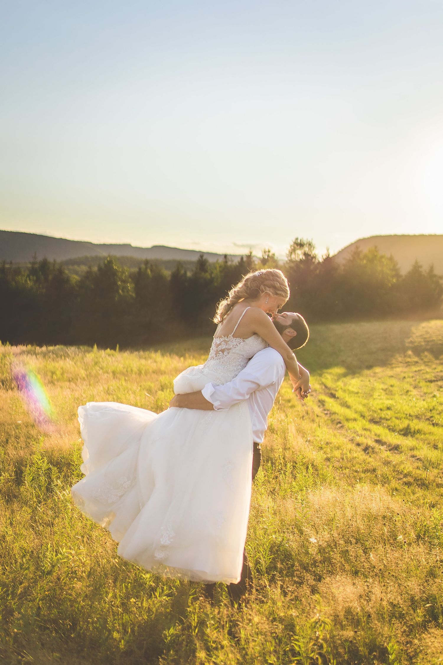 Romantic sunset moment captured in a wildflower field with rolling hills.
