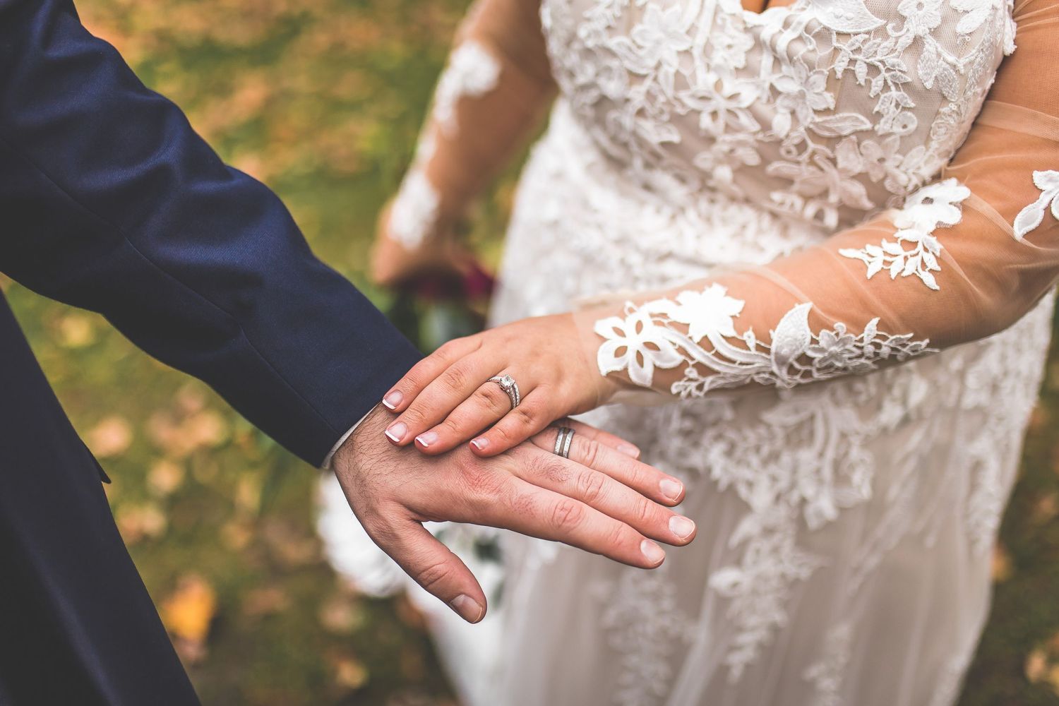 Close-up details of lace wedding dress with delicate floral patterns.