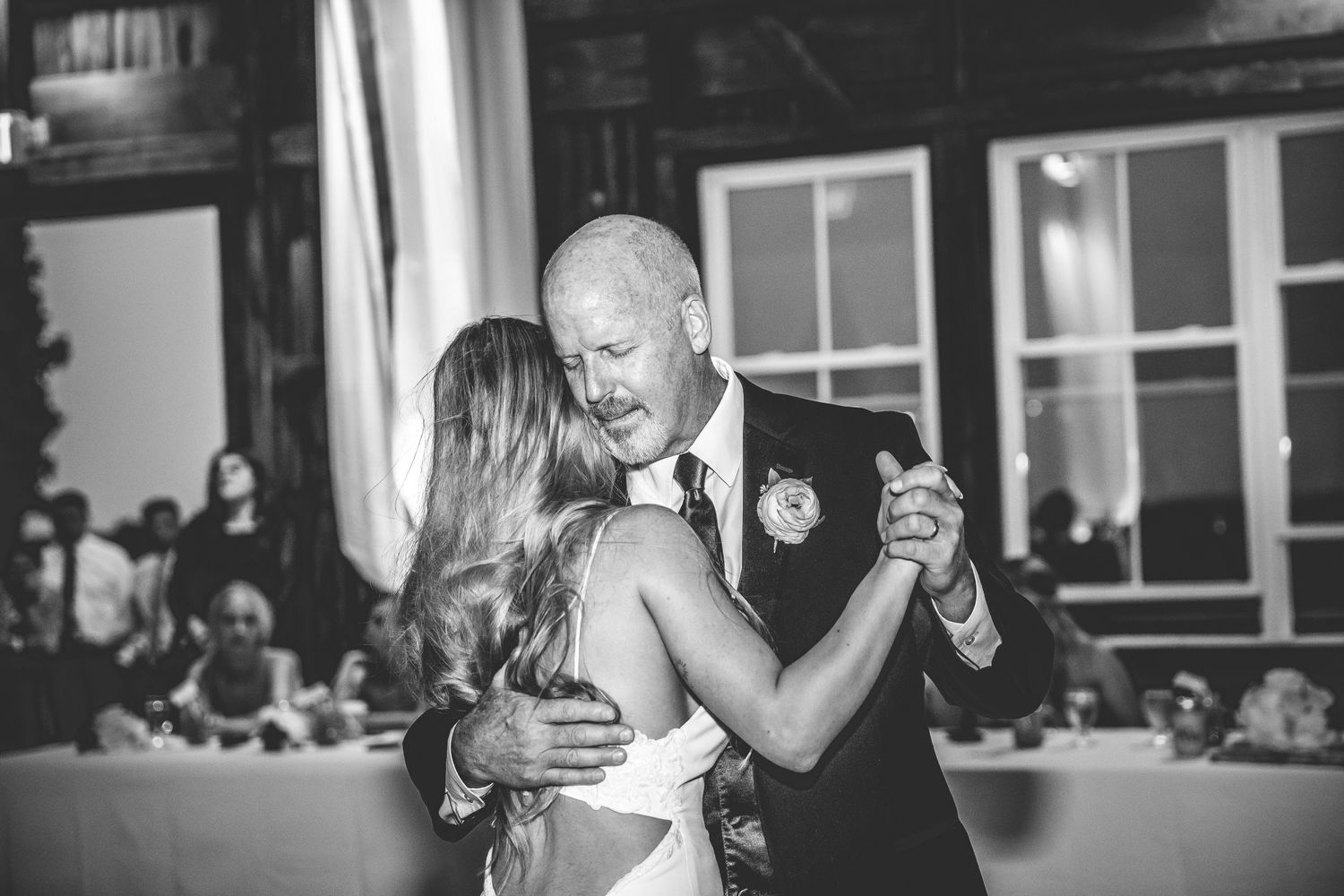 Black and white photos of couples dancing at an elegant indoor wedding reception.