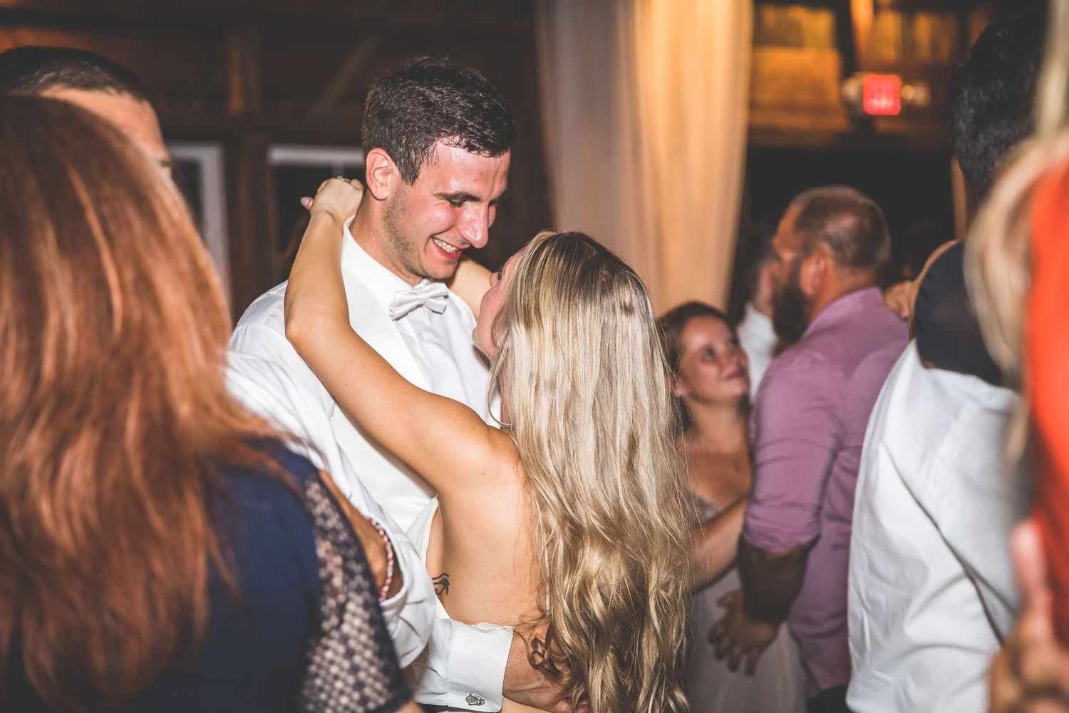 A couple shares an intimate dance together during their wedding reception celebration.