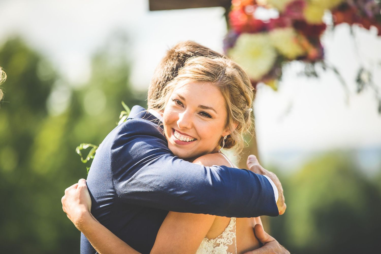 A joyful wedding celebration moment captured in a sunny outdoor setting.
