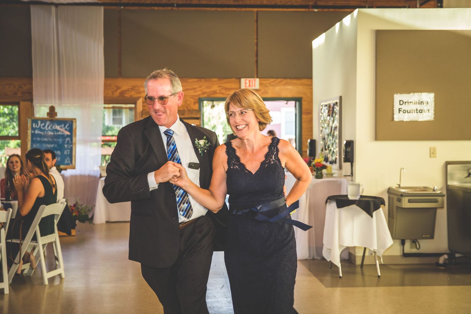 A couple dancing together at an indoor wedding reception venue.