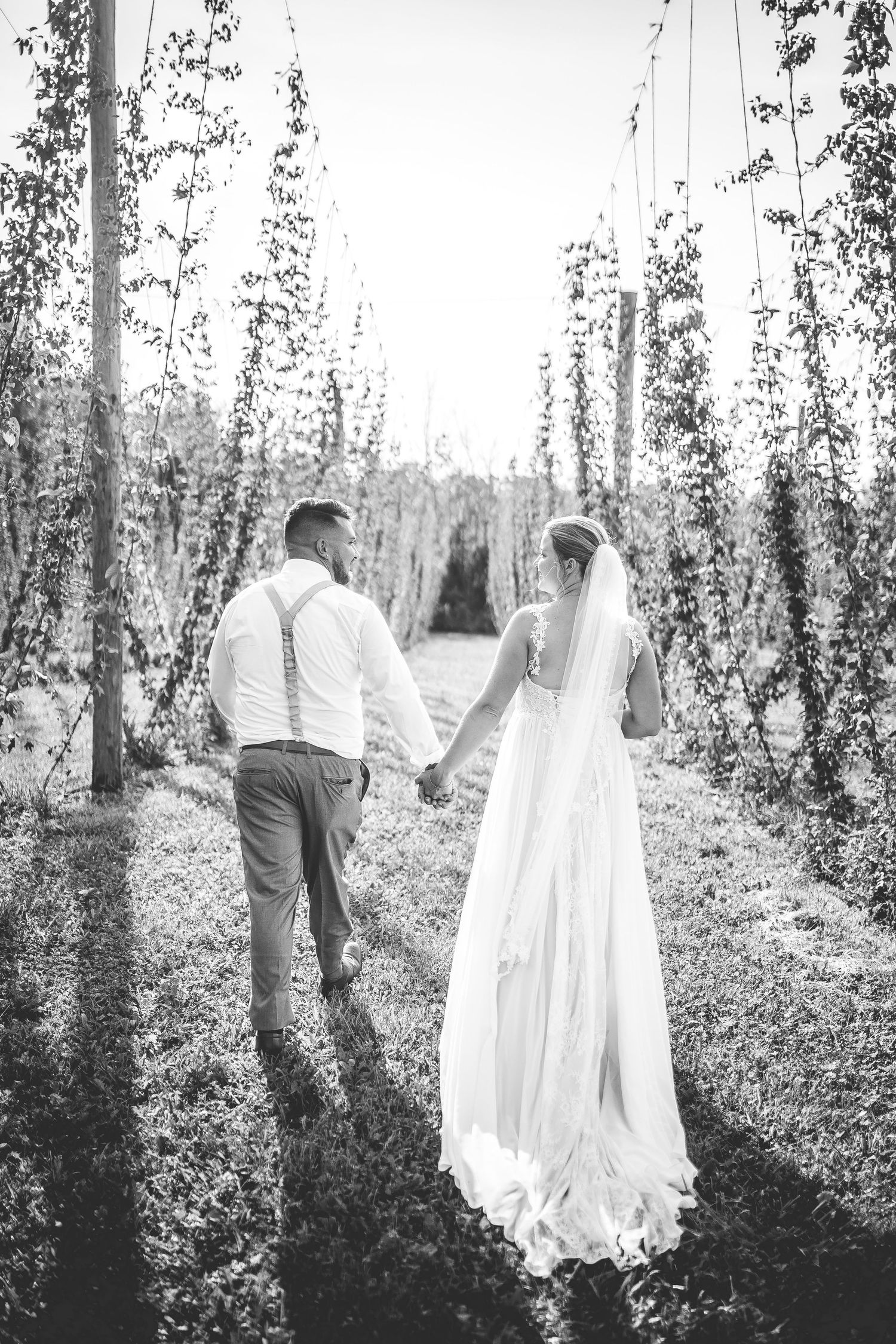 A romantic wedding photo shoot in a serene grove of birch trees captured in black and white.