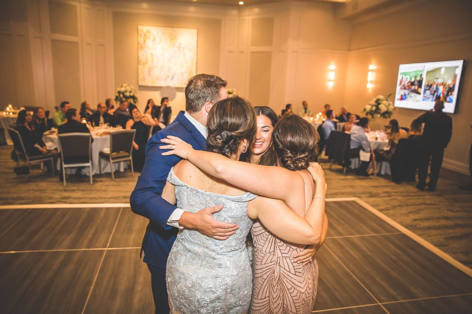 Panoramic view of a wedding reception venue with couples dancing on the dance floor.