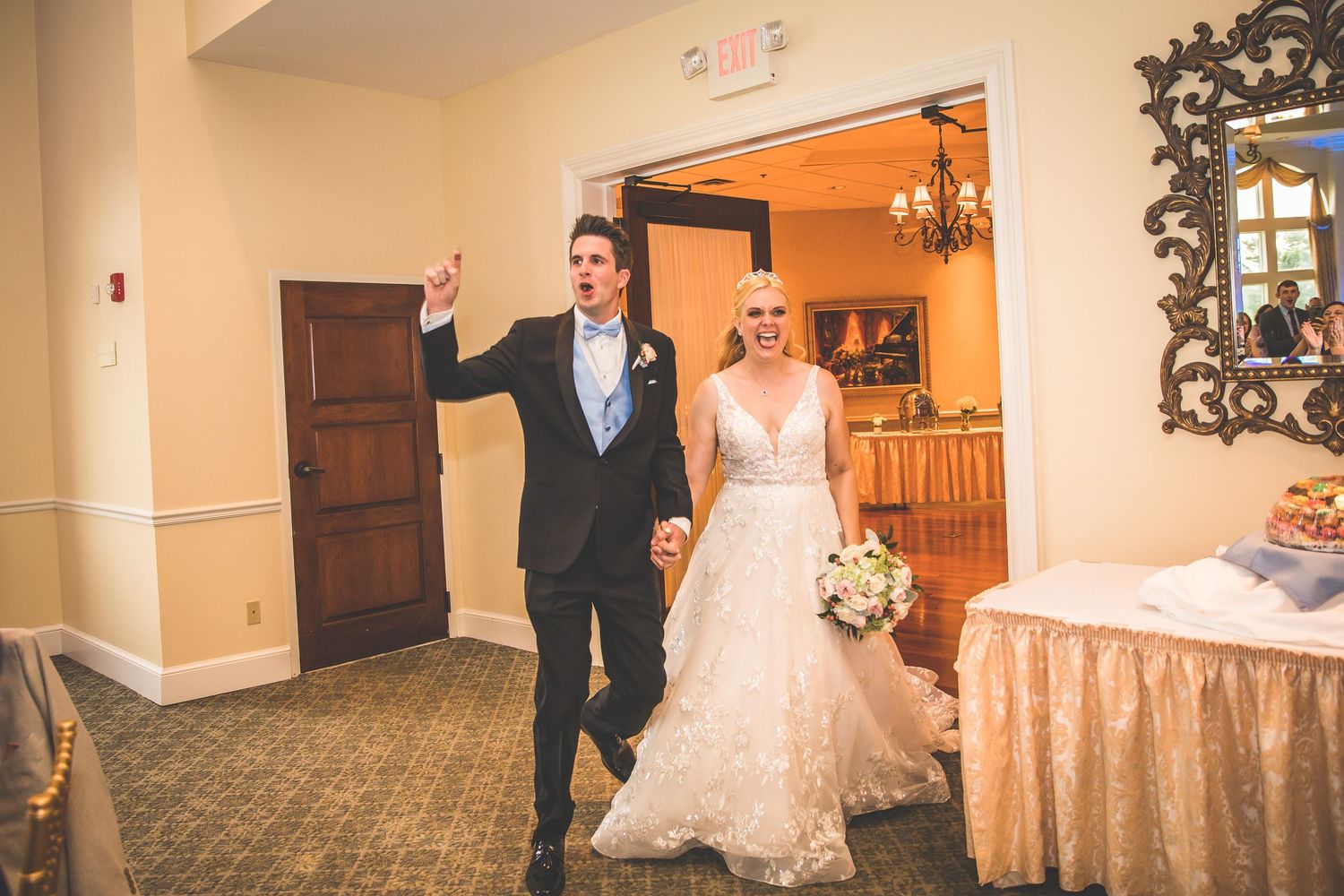 Newlyweds make their grand entrance into an elegant reception hall.