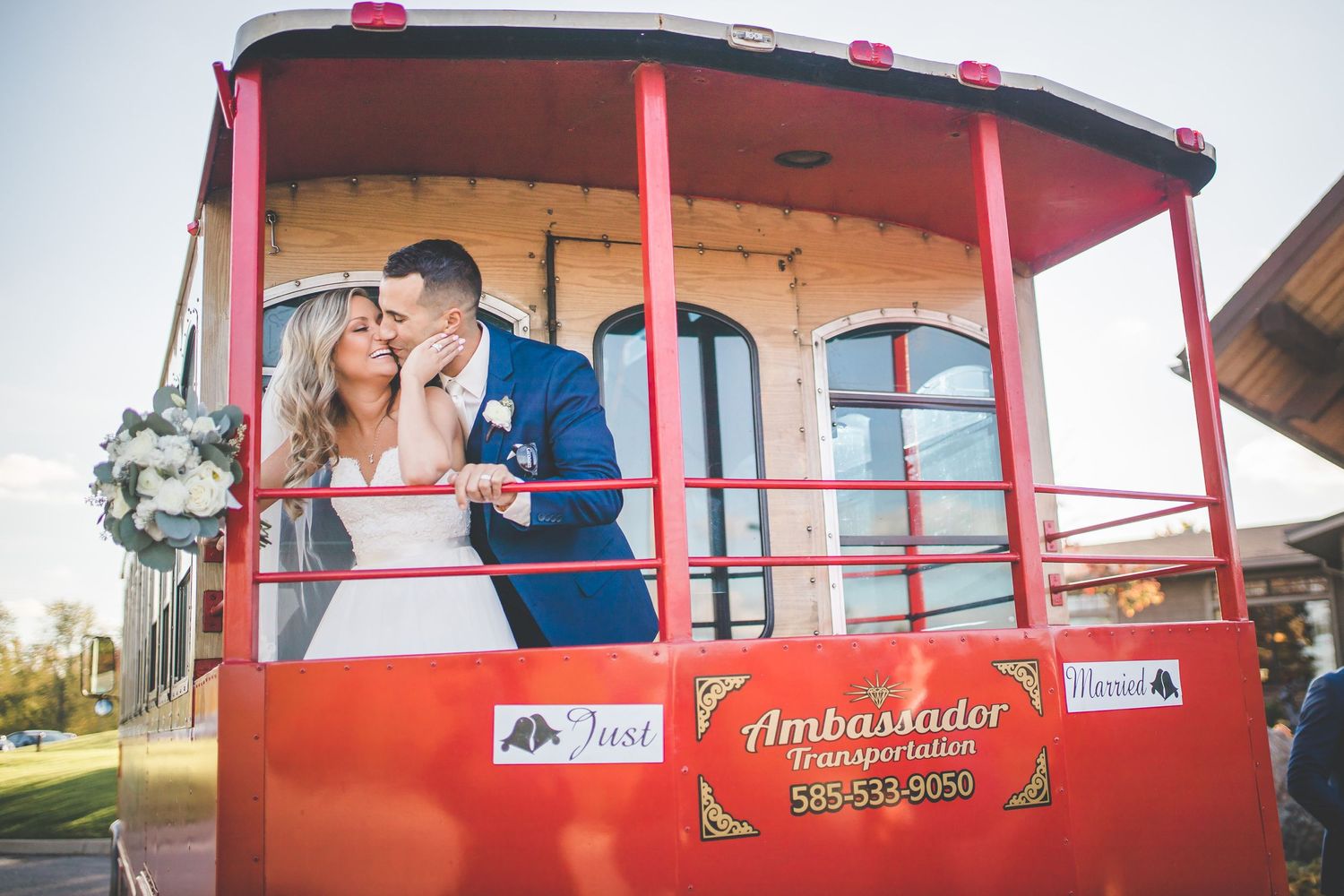 Red vintage trolley car decorated for a wedding celebration.
