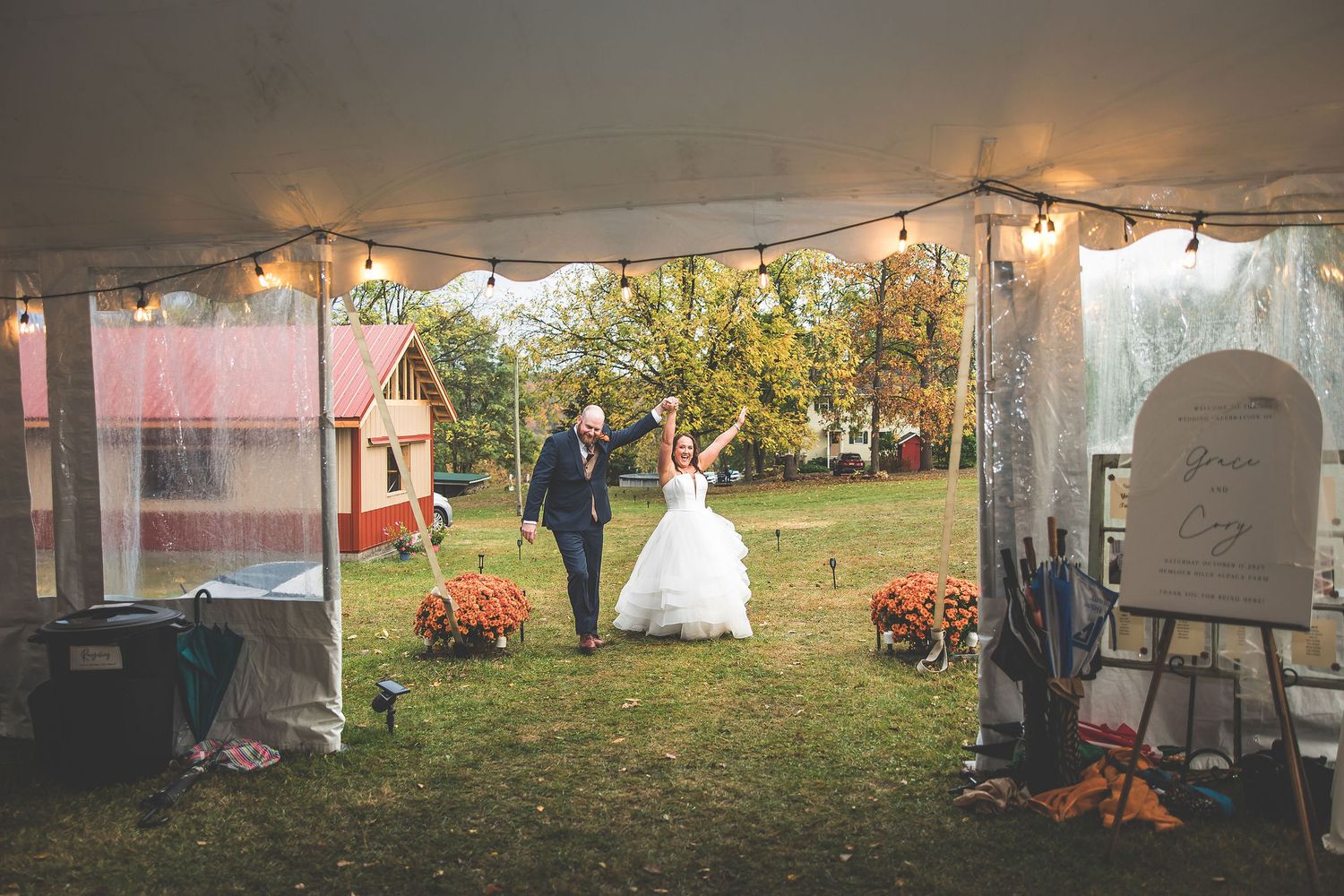 Wedding reception space with white tent walls and string lights creating an intimate atmosphere.