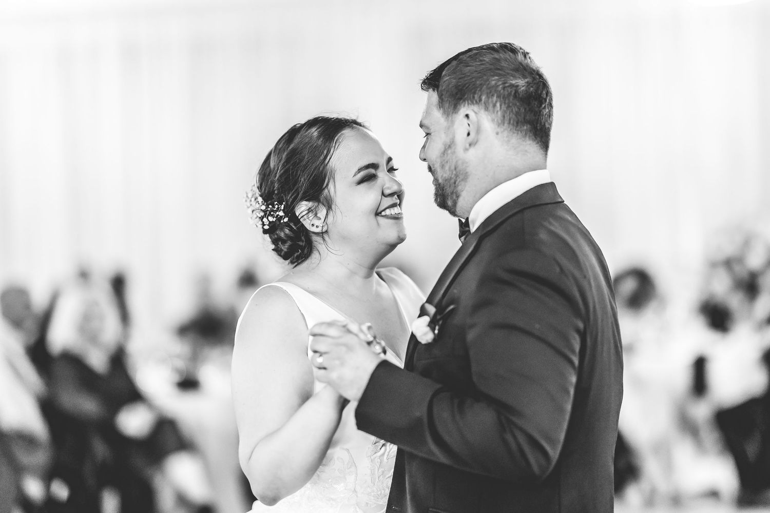 A joyful black and white moment captured during a wedding dance.