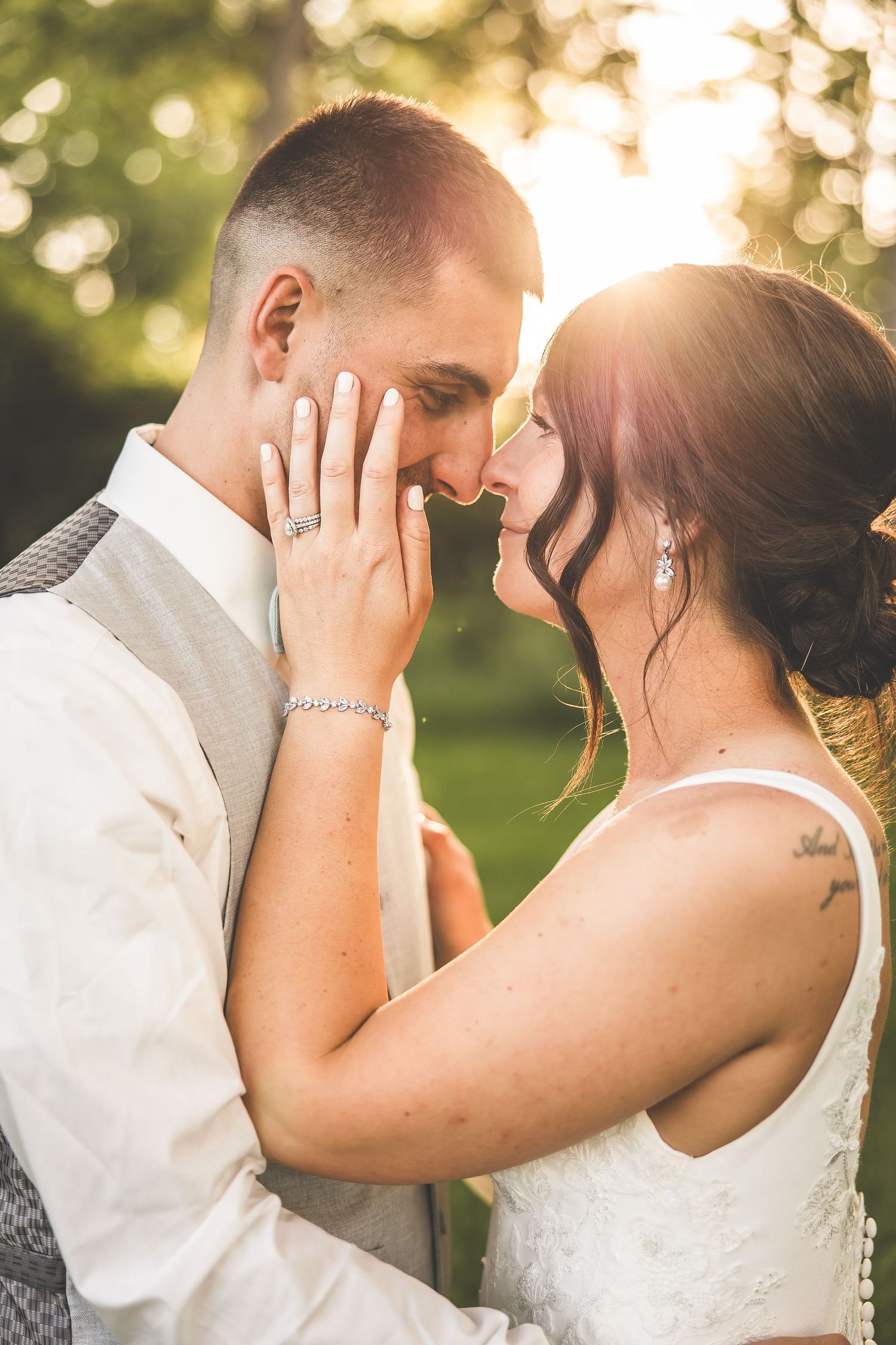 An intimate moment captured between newlyweds in warm evening sunlight.