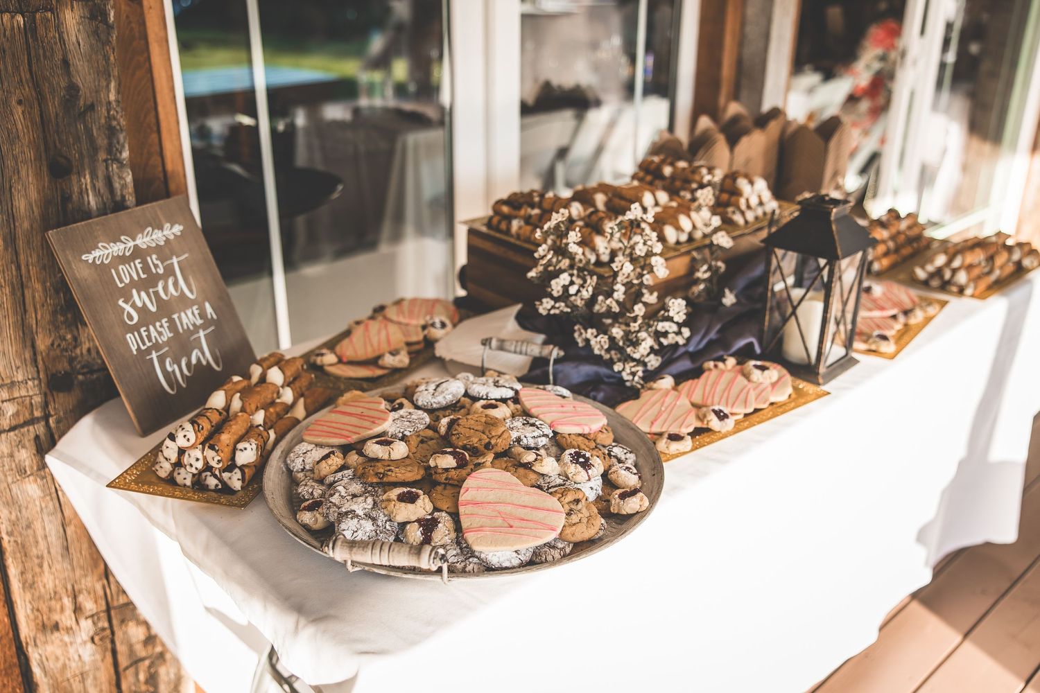 Close-up of decorated wedding cookies and treats arranged on serving platters.