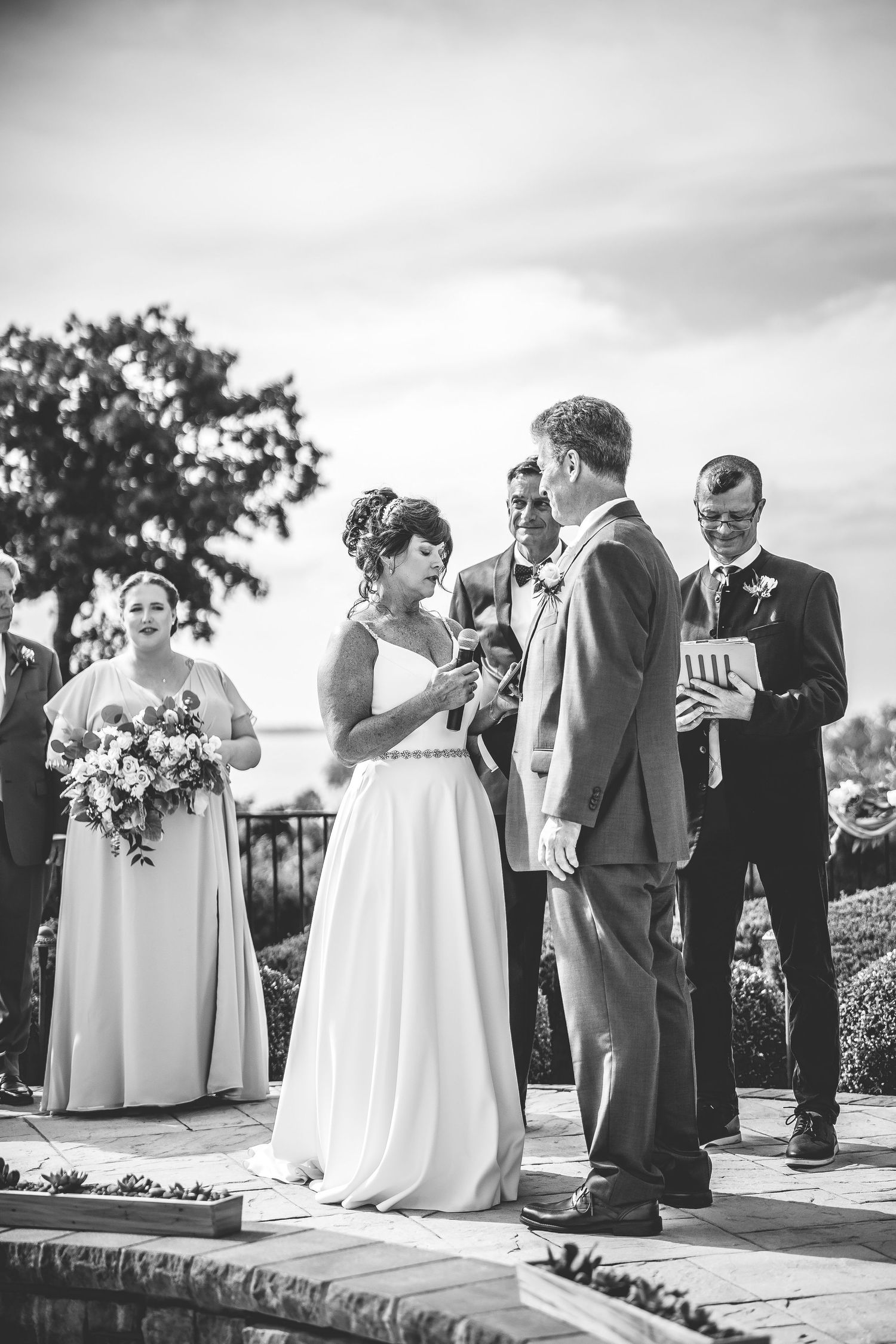 Black and white wedding ceremony moments captured on an elegant outdoor terrace.