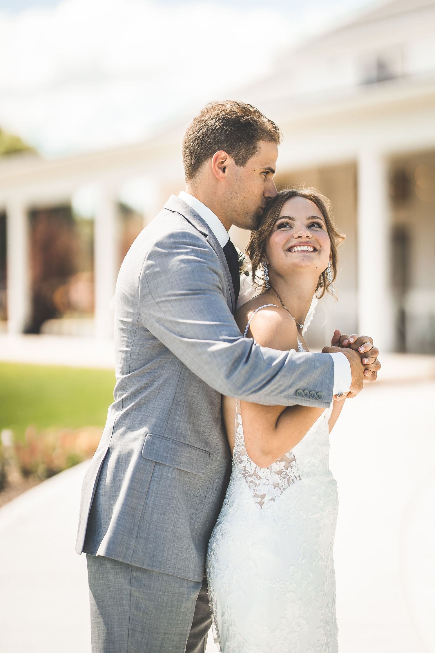 Candid moments of a couple dancing and laughing during their wedding day.