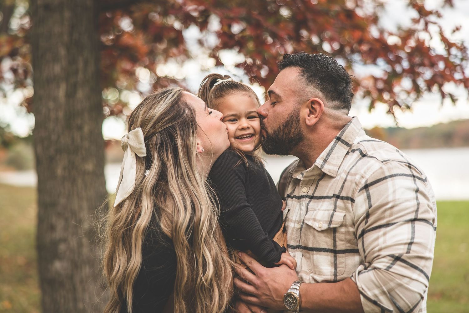 An intimate outdoor portrait session captured against autumn trees.