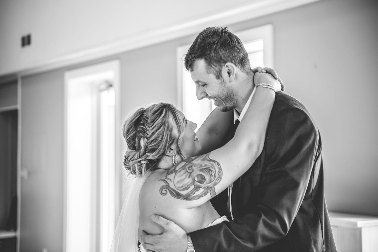 Intimate wedding moments captured in black and white photography indoors.