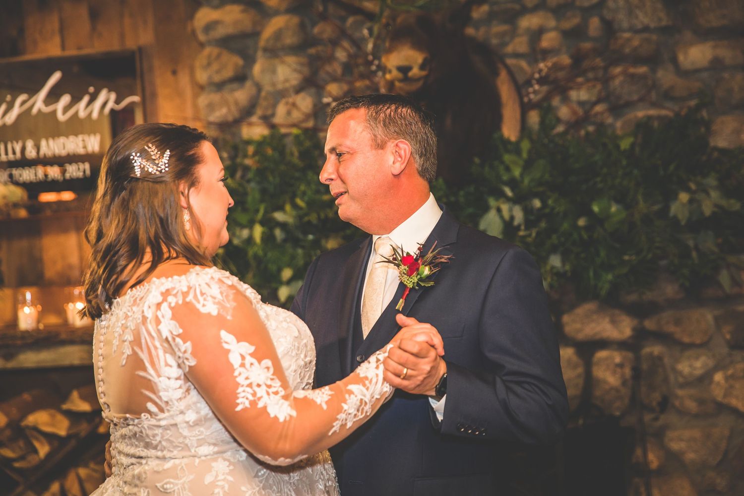 Couple performs romantic dance moves in an elegant rustic reception venue.