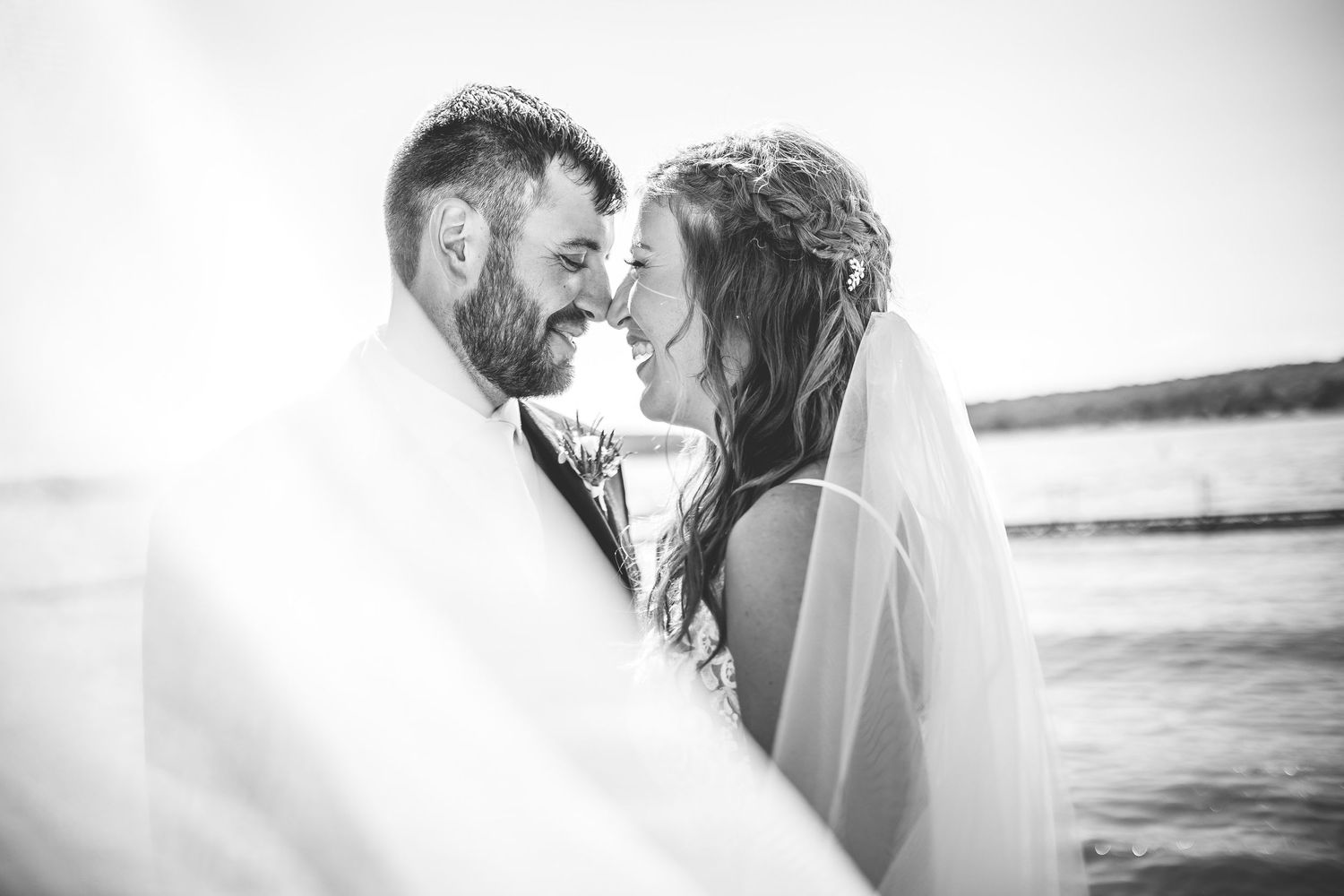Black and white romantic wedding portraits captured by the water.