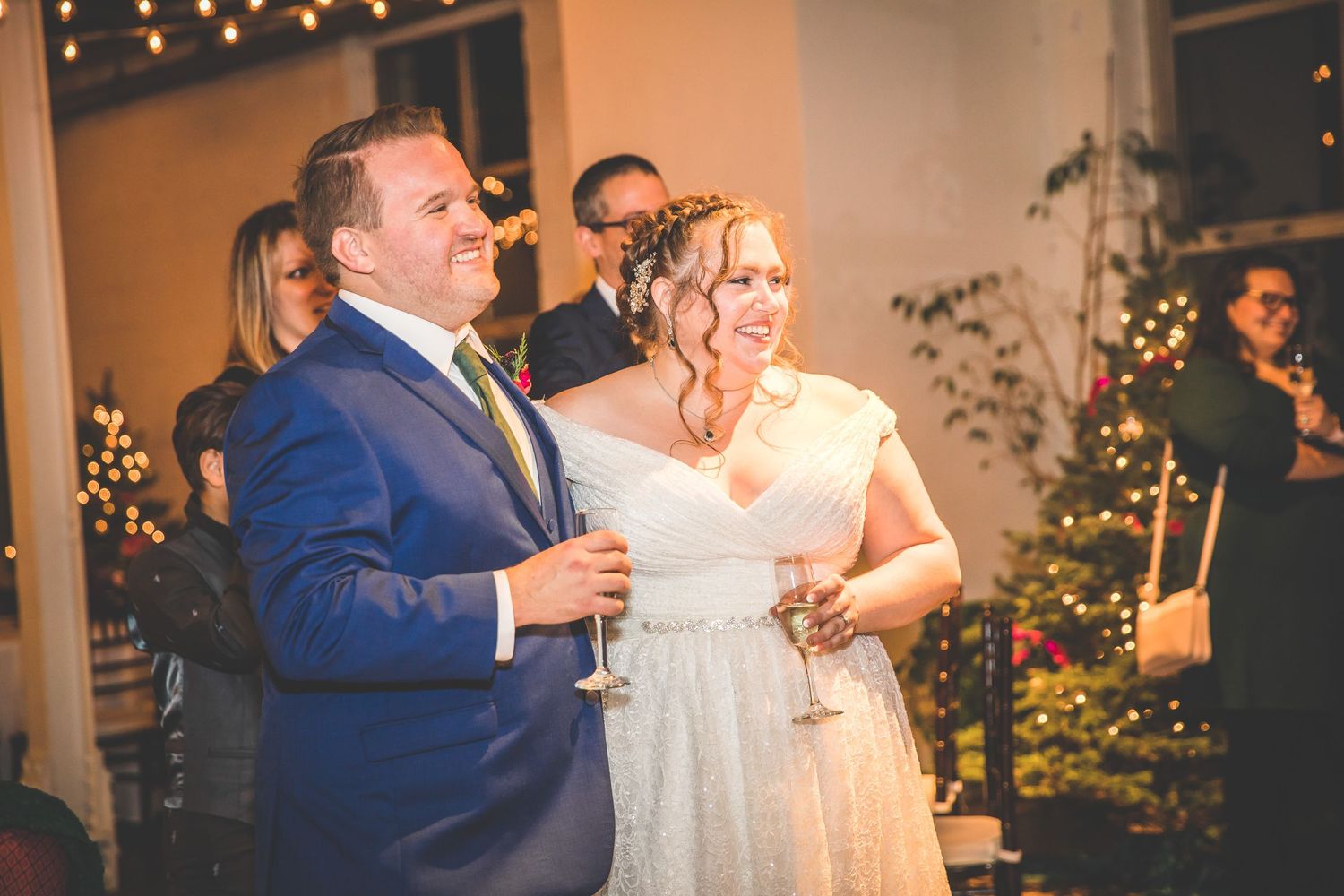 Wedding celebration with couples dancing under ambient lighting and elegant decorations.
