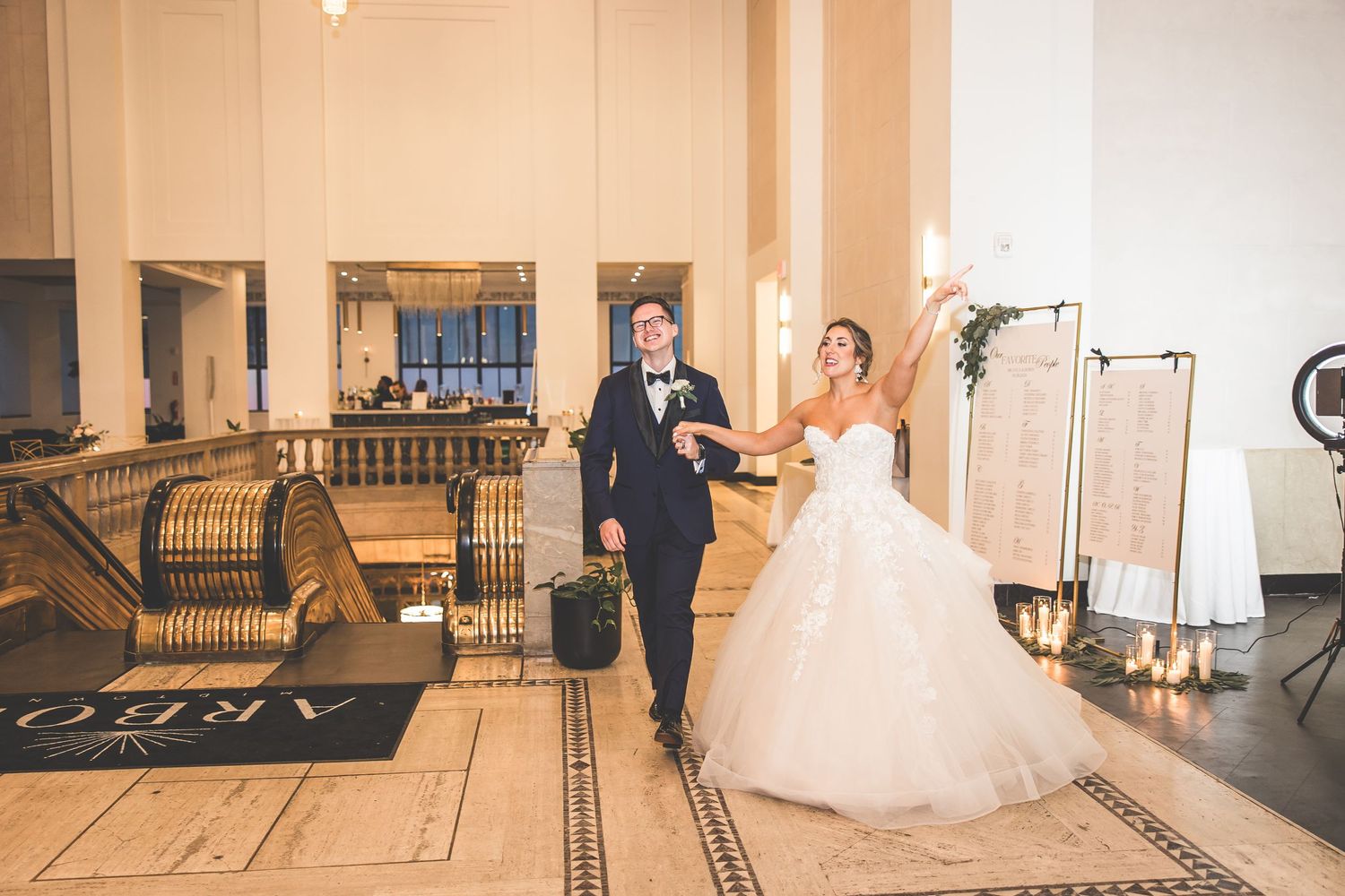 Elegant first dance sequence in a grand ballroom with white columns and chandelier lighting.