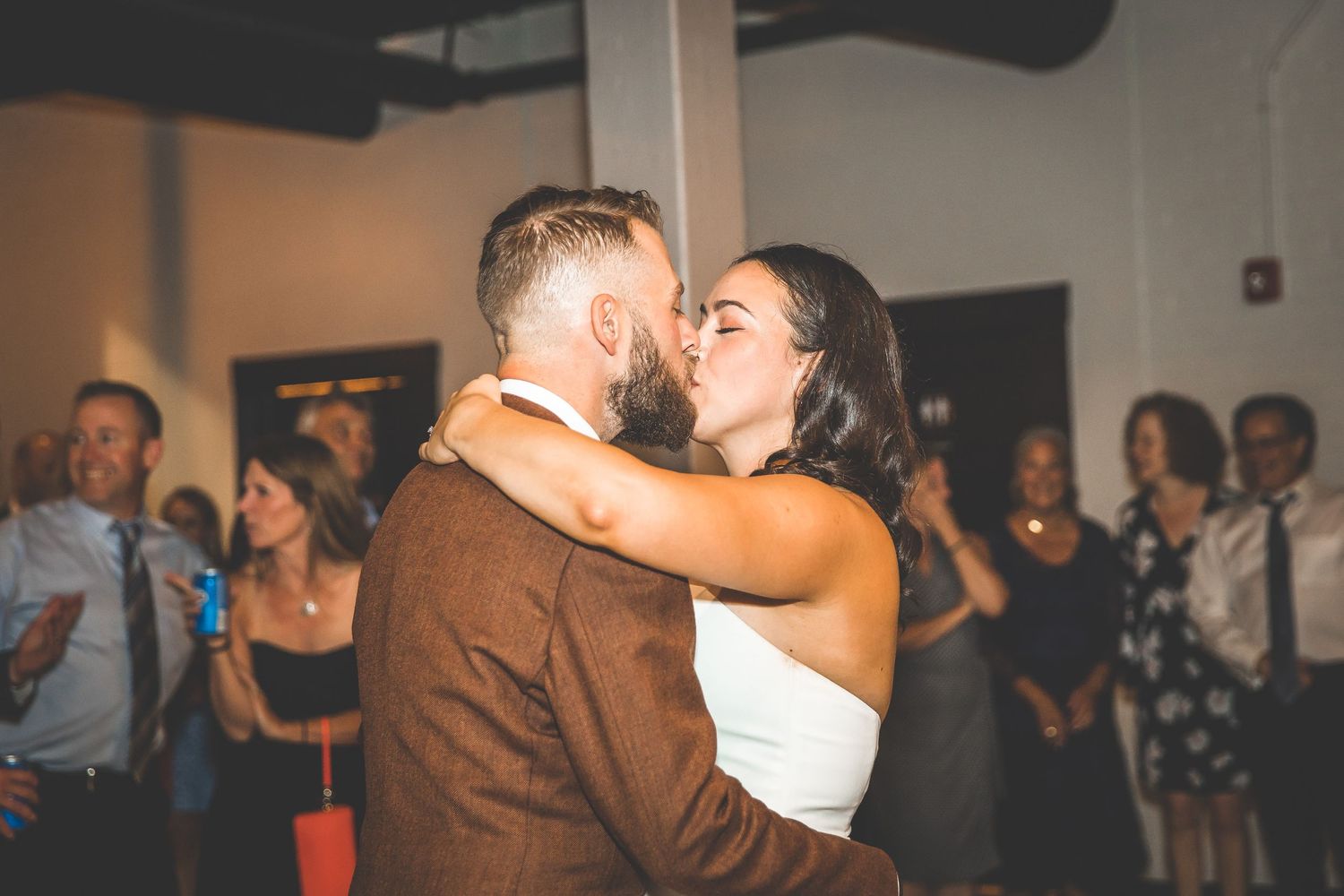 A romantic dance embrace between newlyweds during their wedding reception celebration.