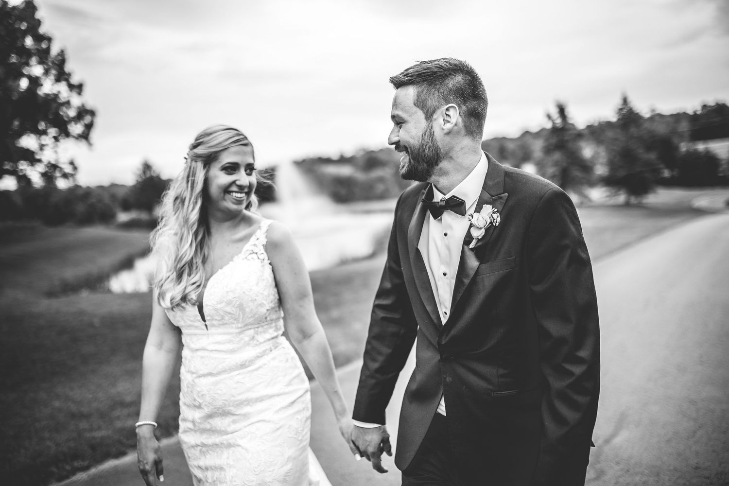 A black and white wedding portrait captures a tender moment between newlyweds on their special day.