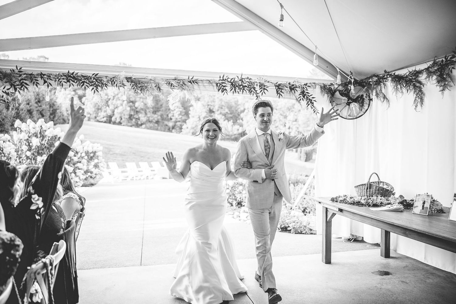 Black and white photos capture dancing and celebration moments under a wedding reception tent.