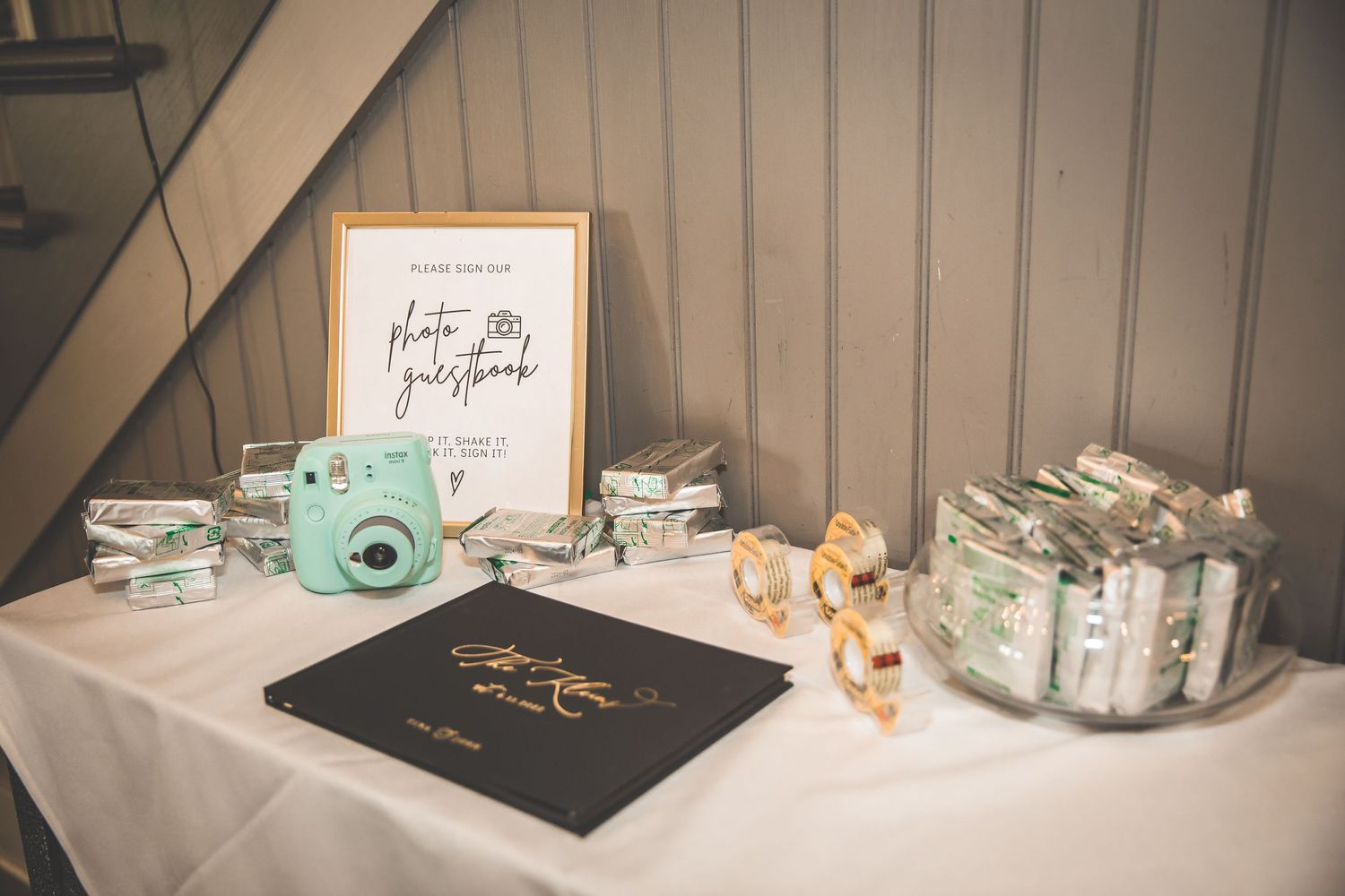 Wedding favor display with personalized items and decorative elements on a shelf.