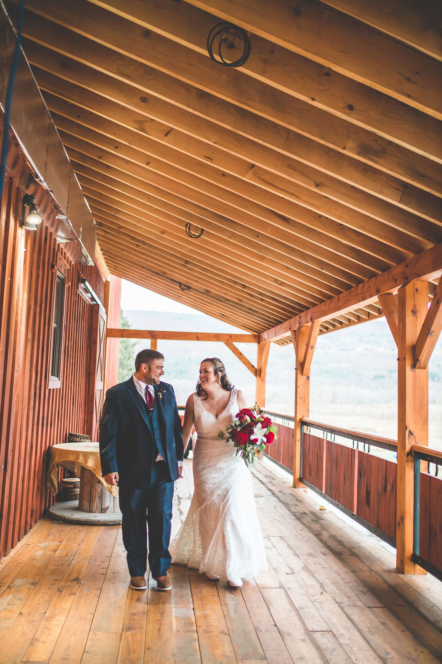 Covered wooden walkway with rustic timber beams and natural lighting.