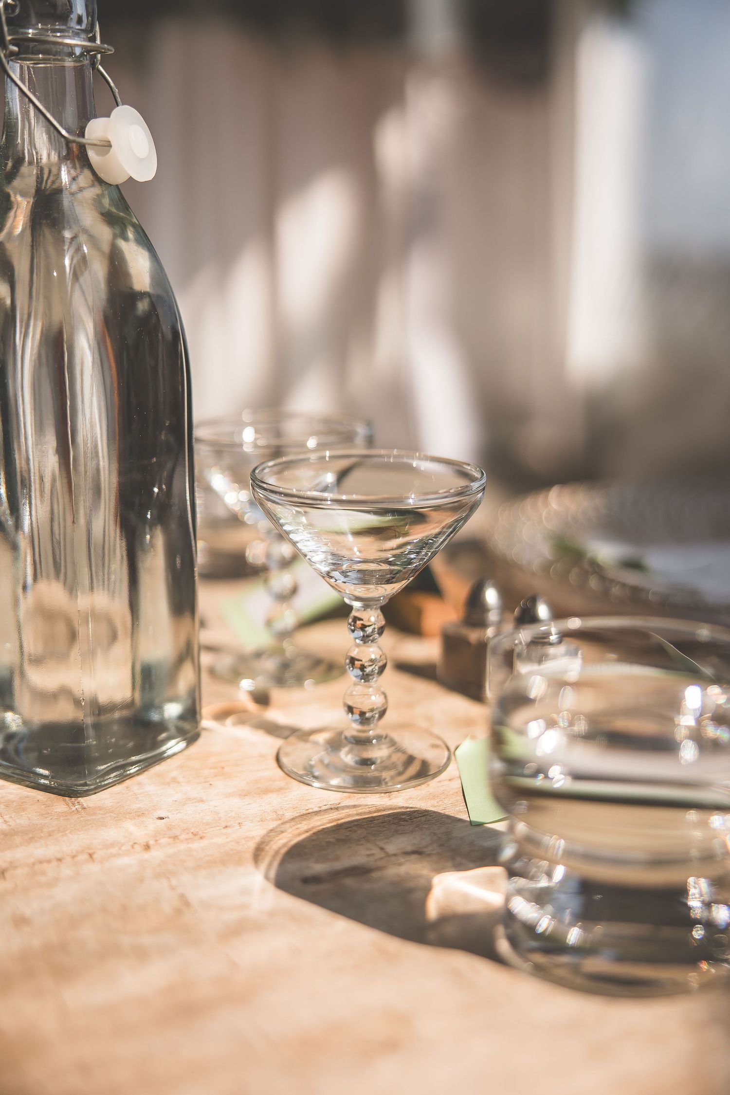 Crystal glassware and table settings arranged on an elegant wedding reception table.