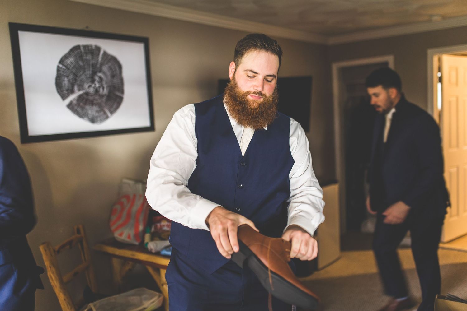 Wedding preparation scene in a dimly lit room with formal attire.