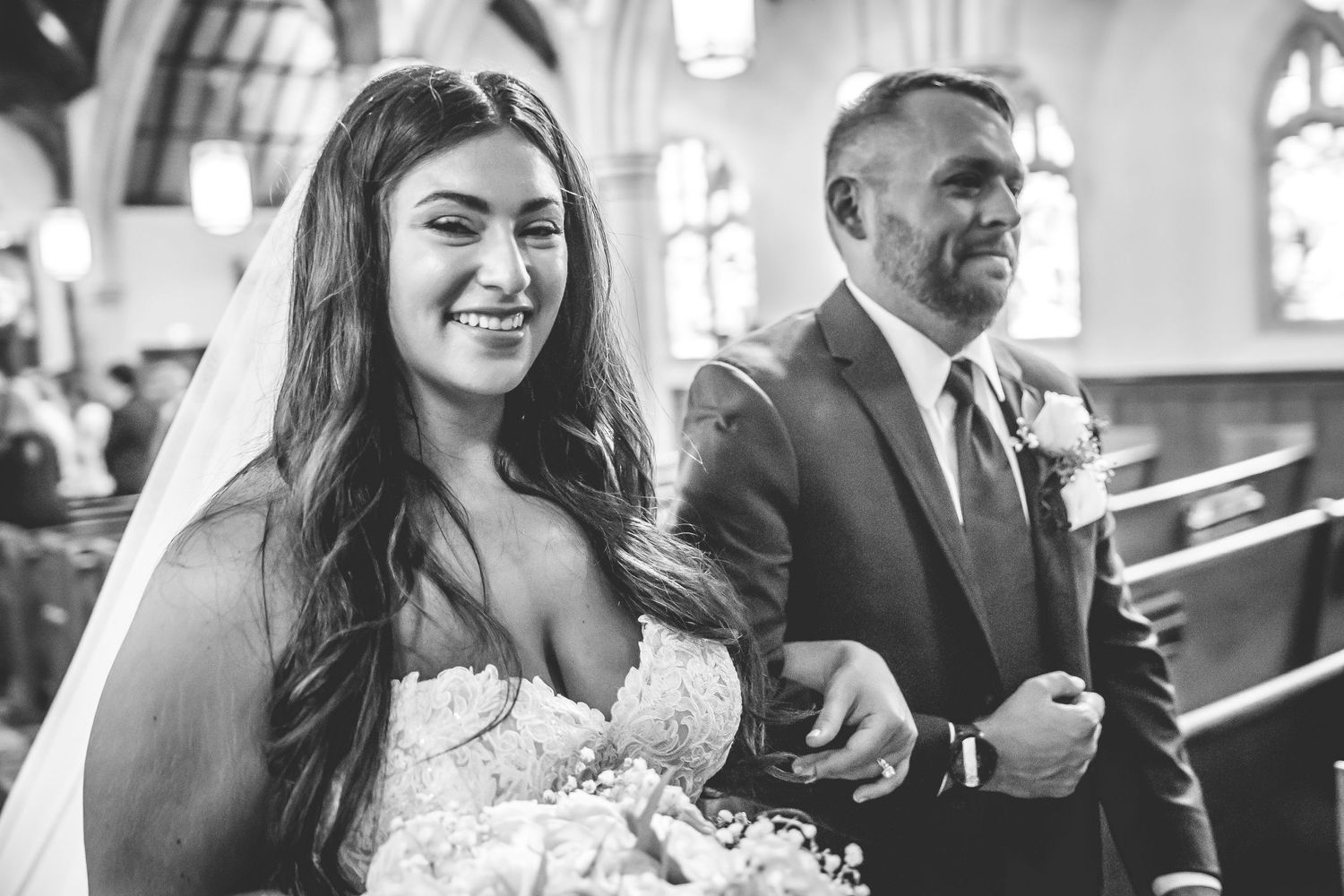 Candid wedding moments captured in a church with natural light streaming through windows.