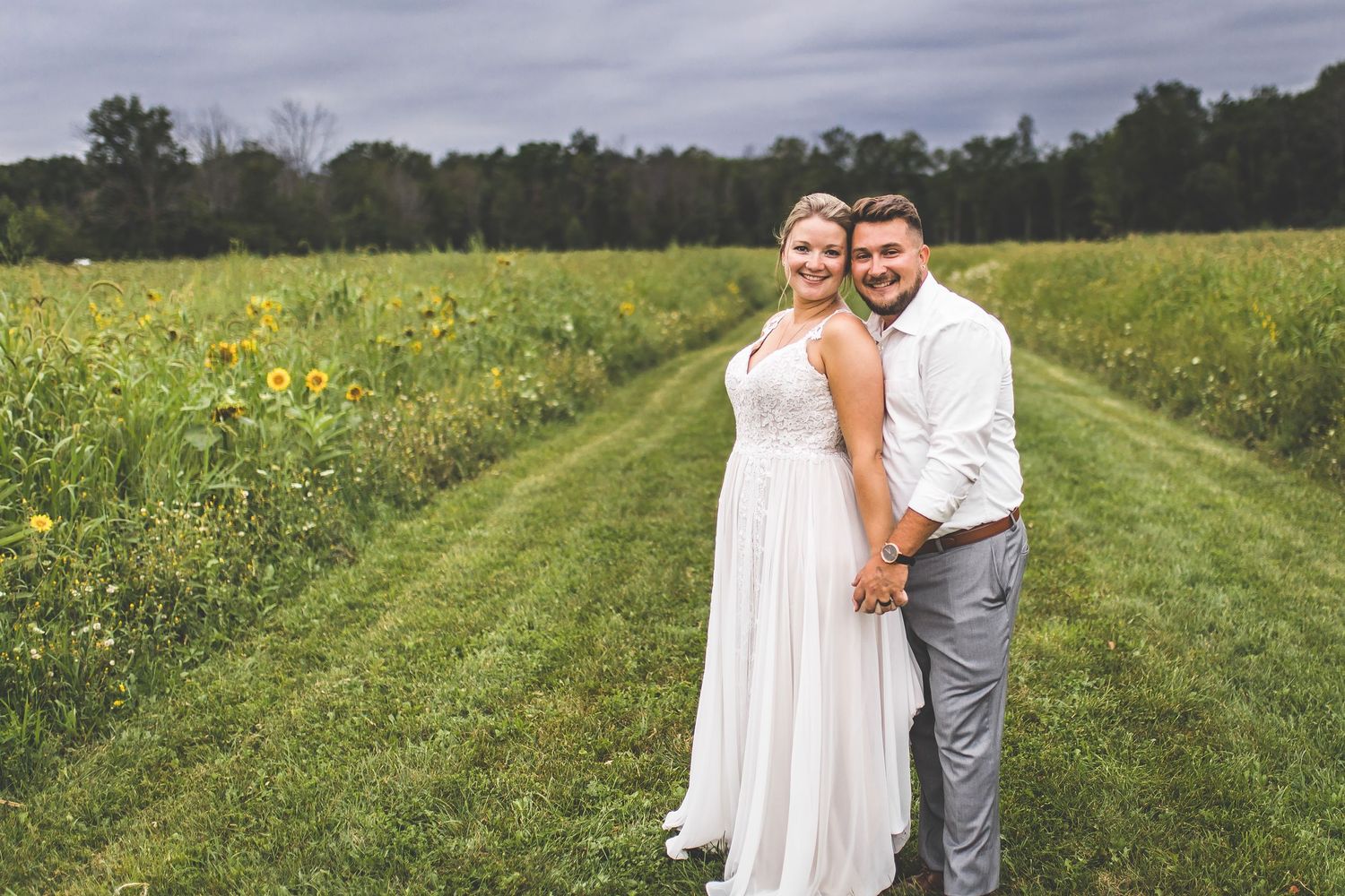 Romantic moment captured between couple in a summer meadow.