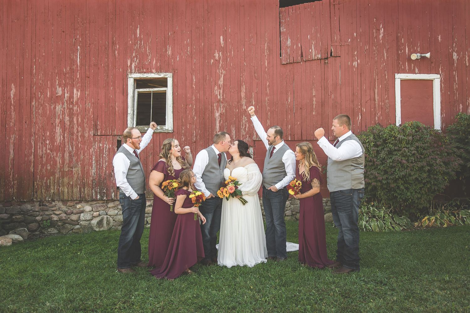 Wedding party members gather for casual group photos against red barn backdrop.