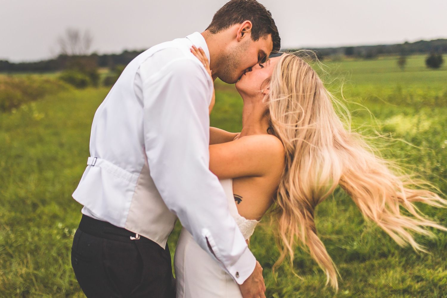 Romantic wedding photography sequence in a sunlit field with golden light.