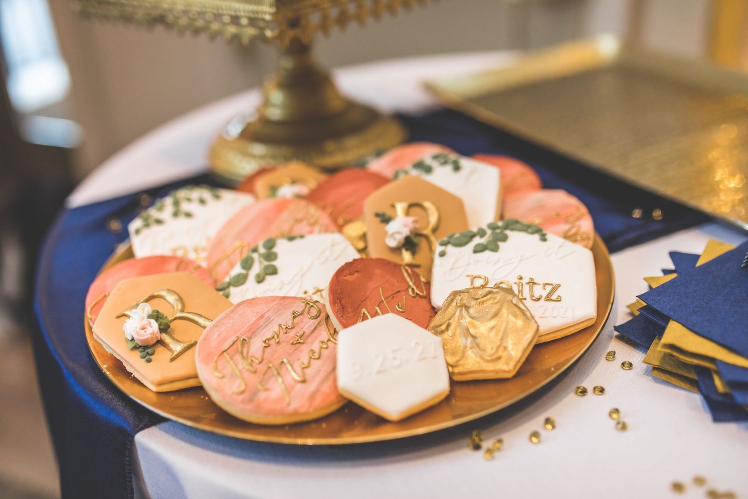 Beautifully decorated sugar cookies with floral designs displayed on a wooden serving board.