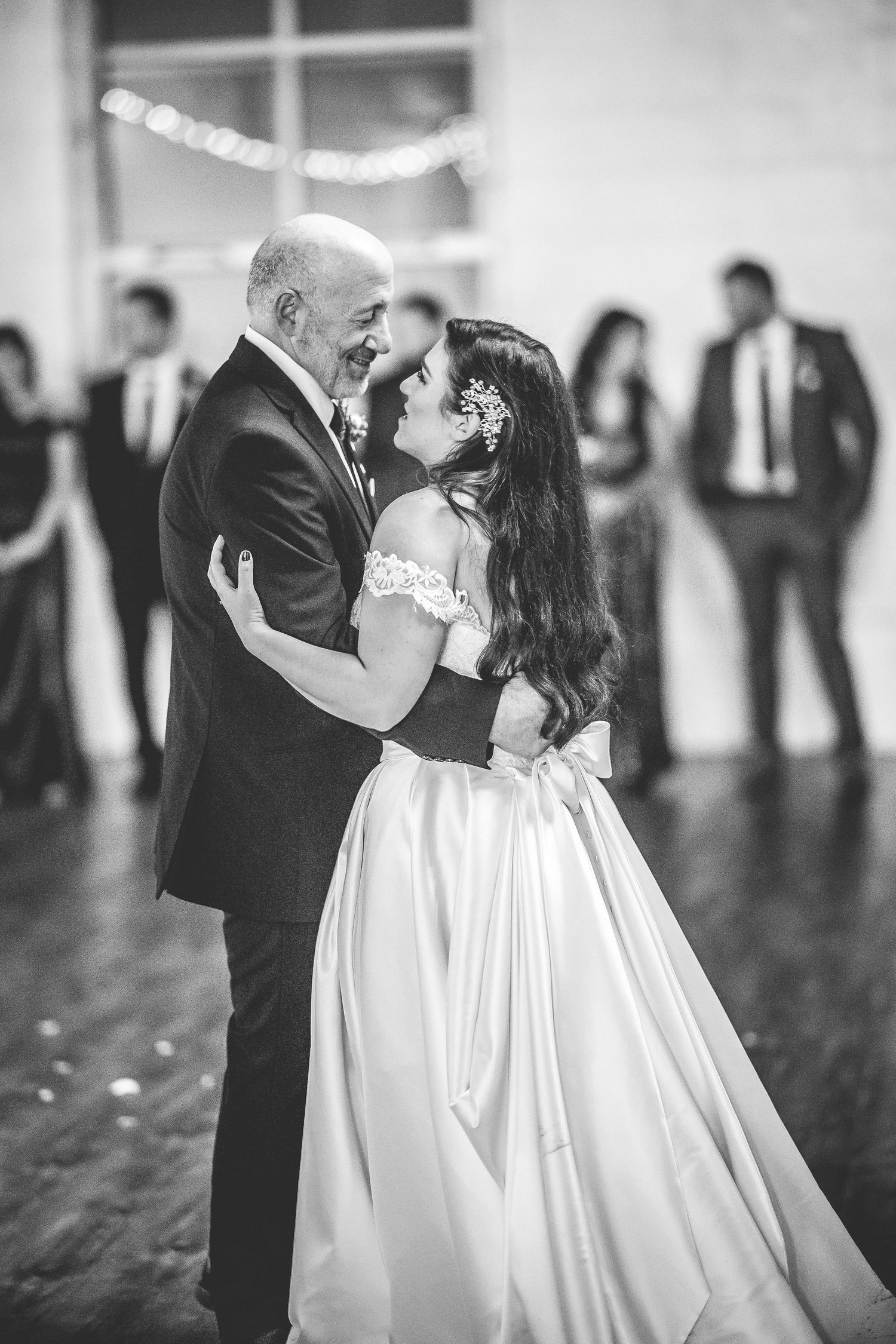 Black and white capture of a tender dance moment at a wedding reception.
