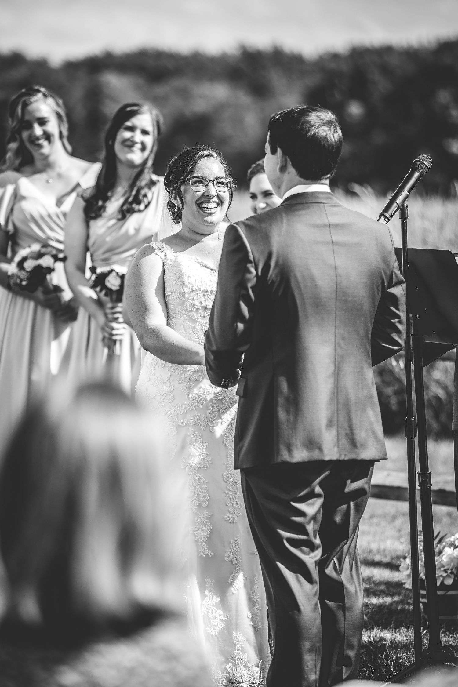 Black and white candid moments from an outdoor wedding ceremony showing guests and wedding party.
