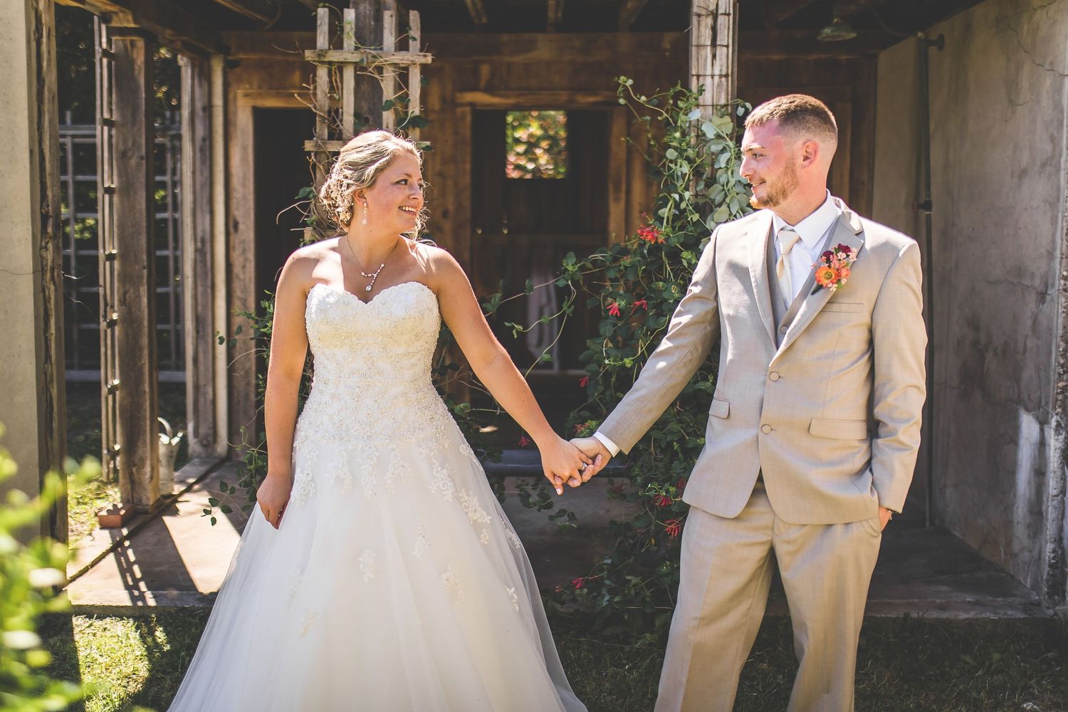 Wedding photography session in an elegant stone building with large windows.