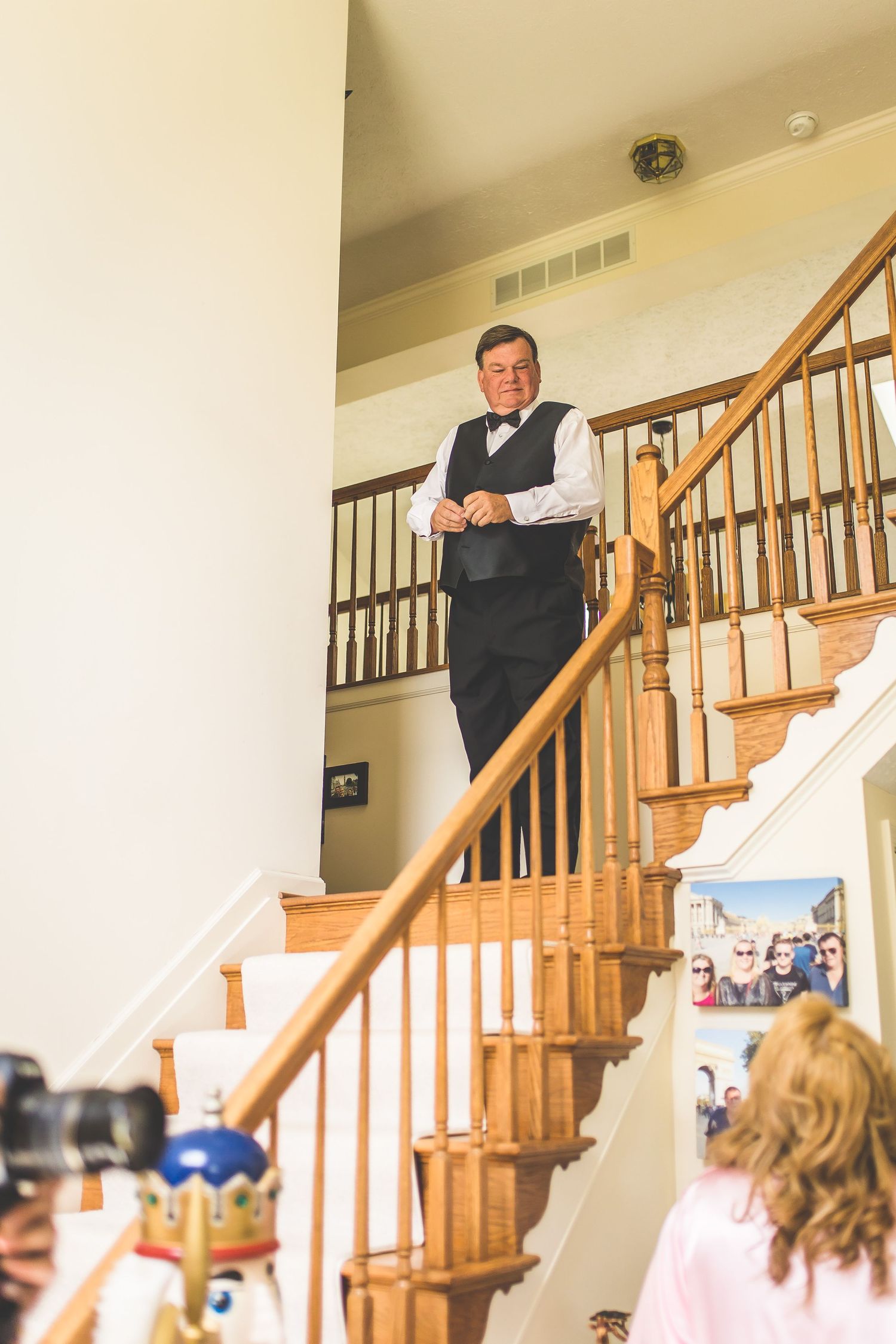 A wooden staircase in a home during wedding preparations.