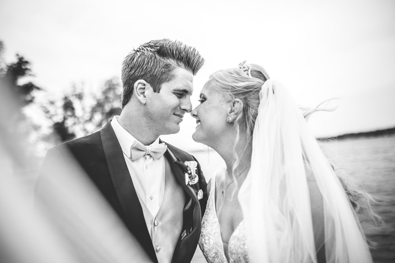 Intimate black and white portrait of newlyweds sharing a tender moment.