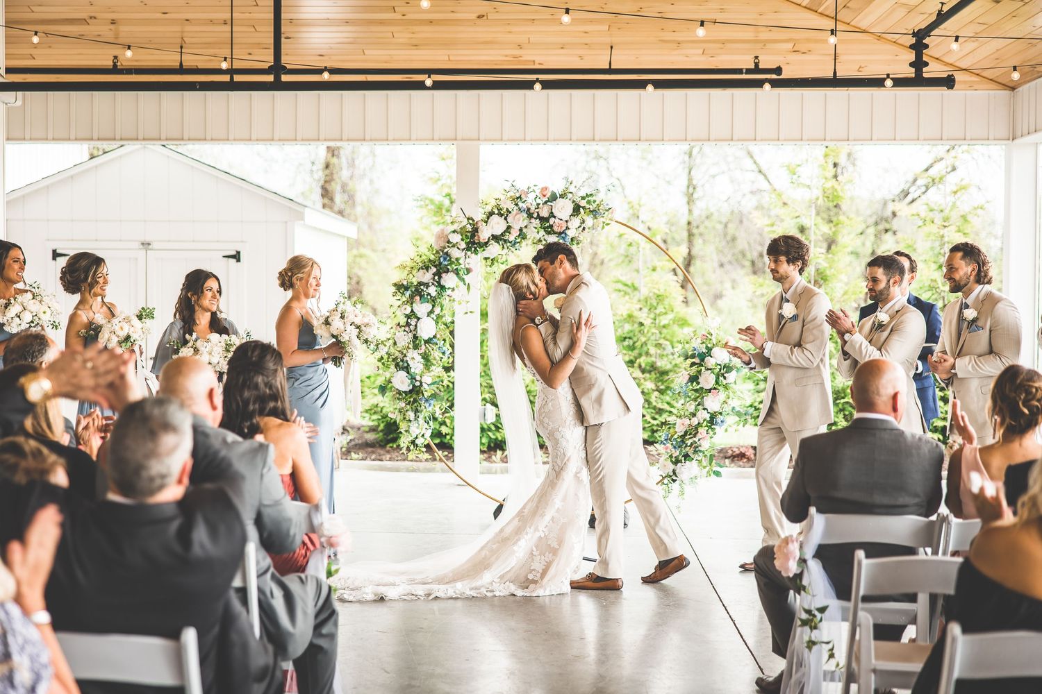 Full view of wedding venue showing ceremony setup and seated guests.