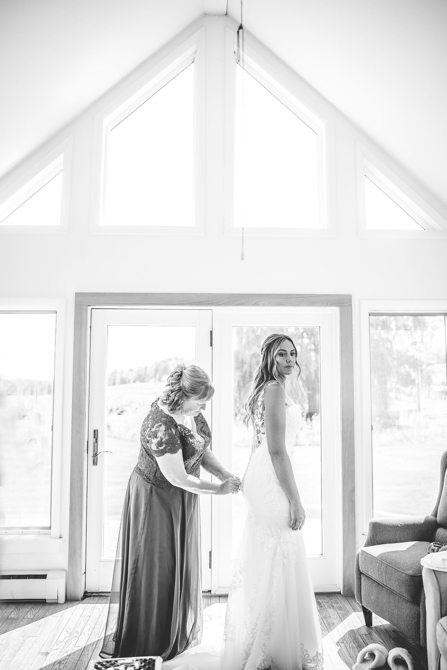 Black and white photos showing wedding dress preparation in sunlit room.