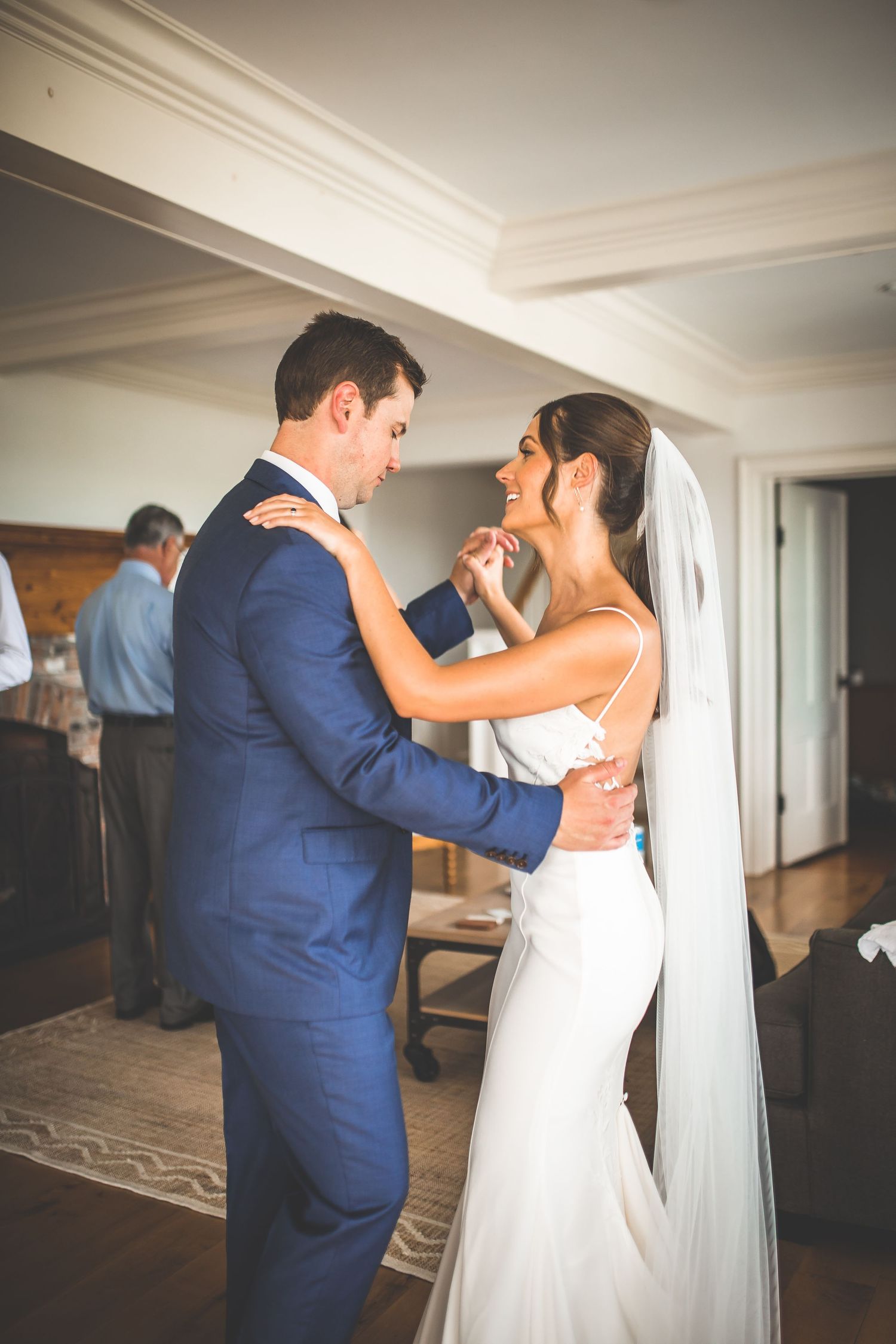 Couple shares their first dance in an elegant indoor venue.