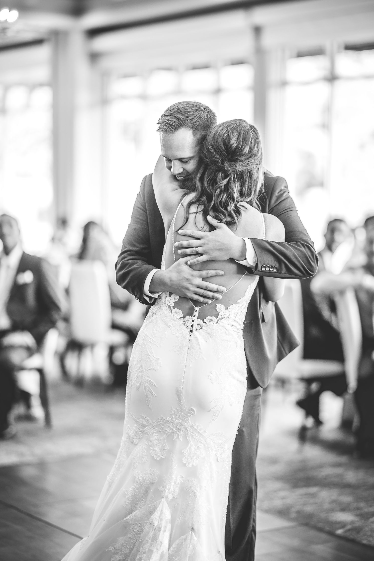 Black and white photos capture an intimate first dance between newlyweds at an elegant indoor reception.