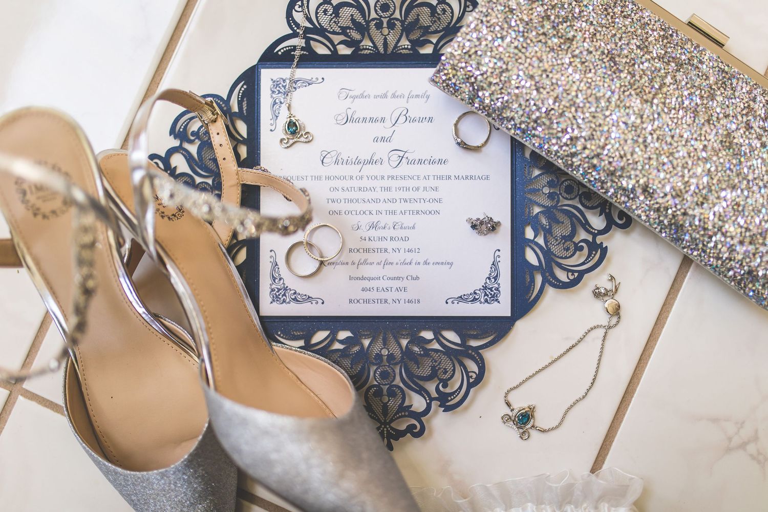 Navy blue laser-cut wedding invitations with glitter accents and elegant calligraphy.