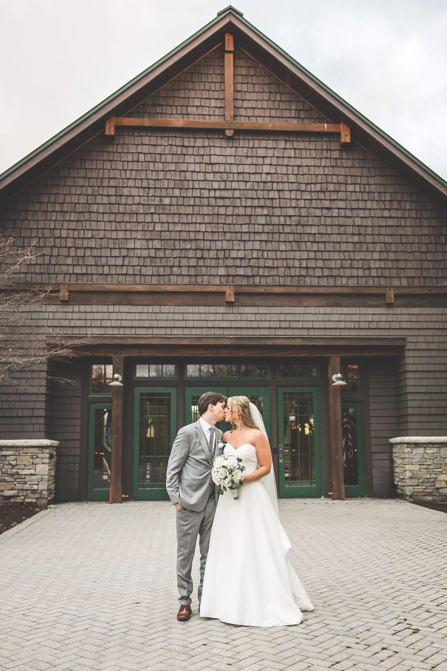 Series of romantic wedding photos taken outside a rustic lodge with stone and wood details.