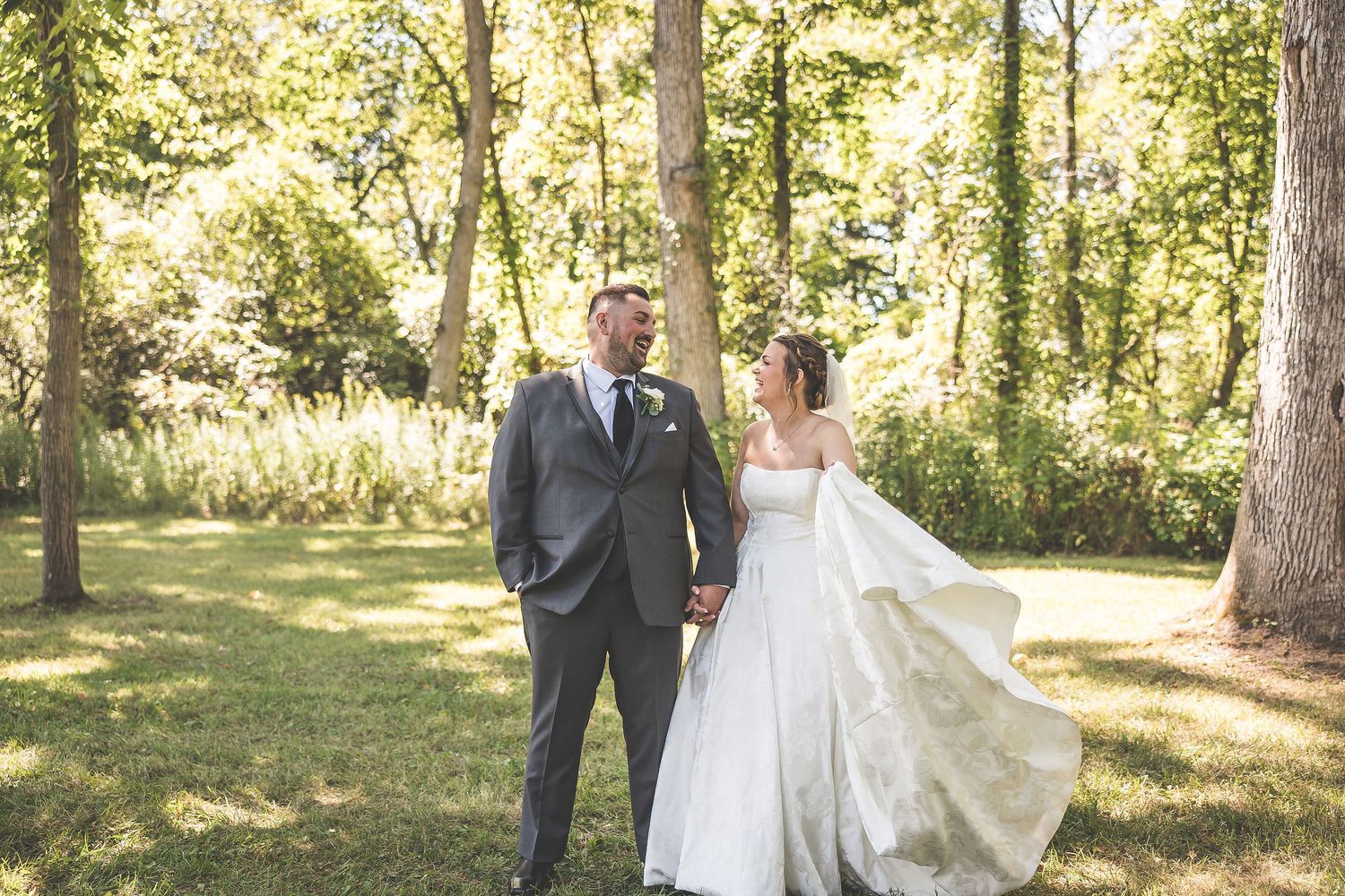 A romantic wedding photoshoot sequence in a sunlit wooded area with a flowing white dress and formal attire.