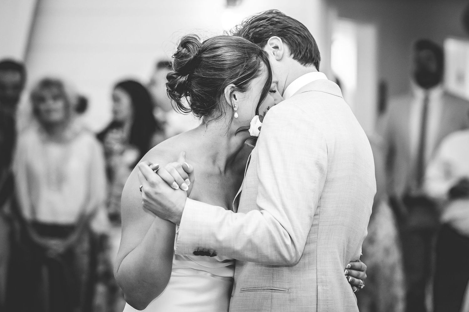 Black and white photo of couples dancing at an elegant wedding reception.